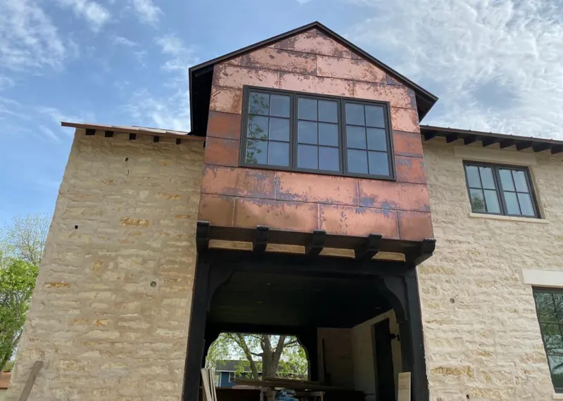 Copper metal panel facade on a stone building for Skylight Installation in Huntington